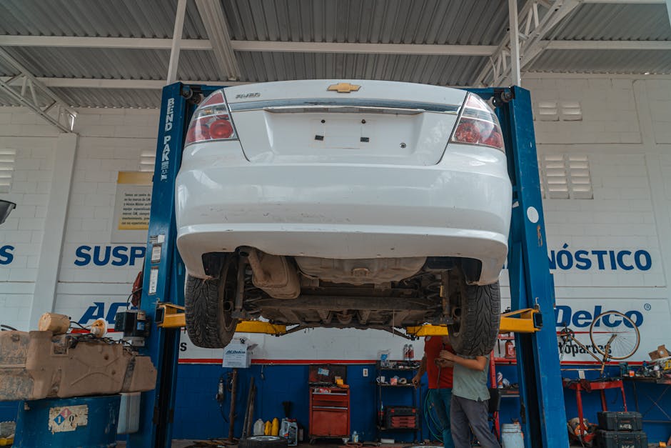 Car elevated on a hydraulic lift for wheel alignment service
